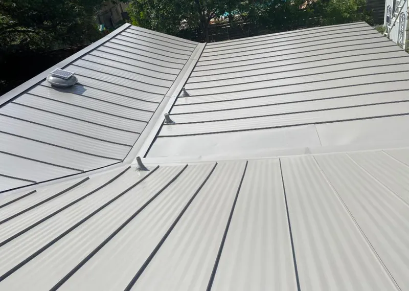 Solar attic fan installed on a metal roof for Roof Ventilation in Wisconsin Rapids